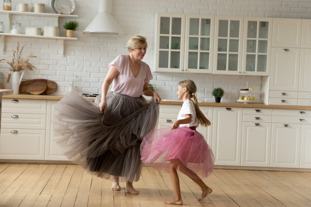 happy energetic grandmother teach ball dances active little girl grandchild